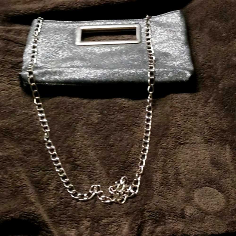 Silver sparkle clutch with braided steel strap that is removable